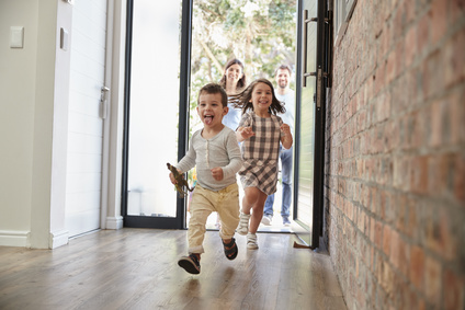 Excited Children Arriving Home With Parents